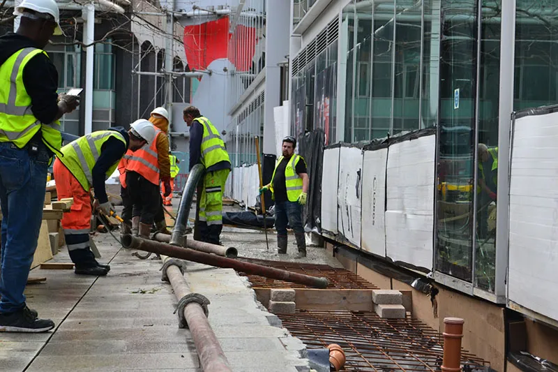 A group of construction workers working on a building.