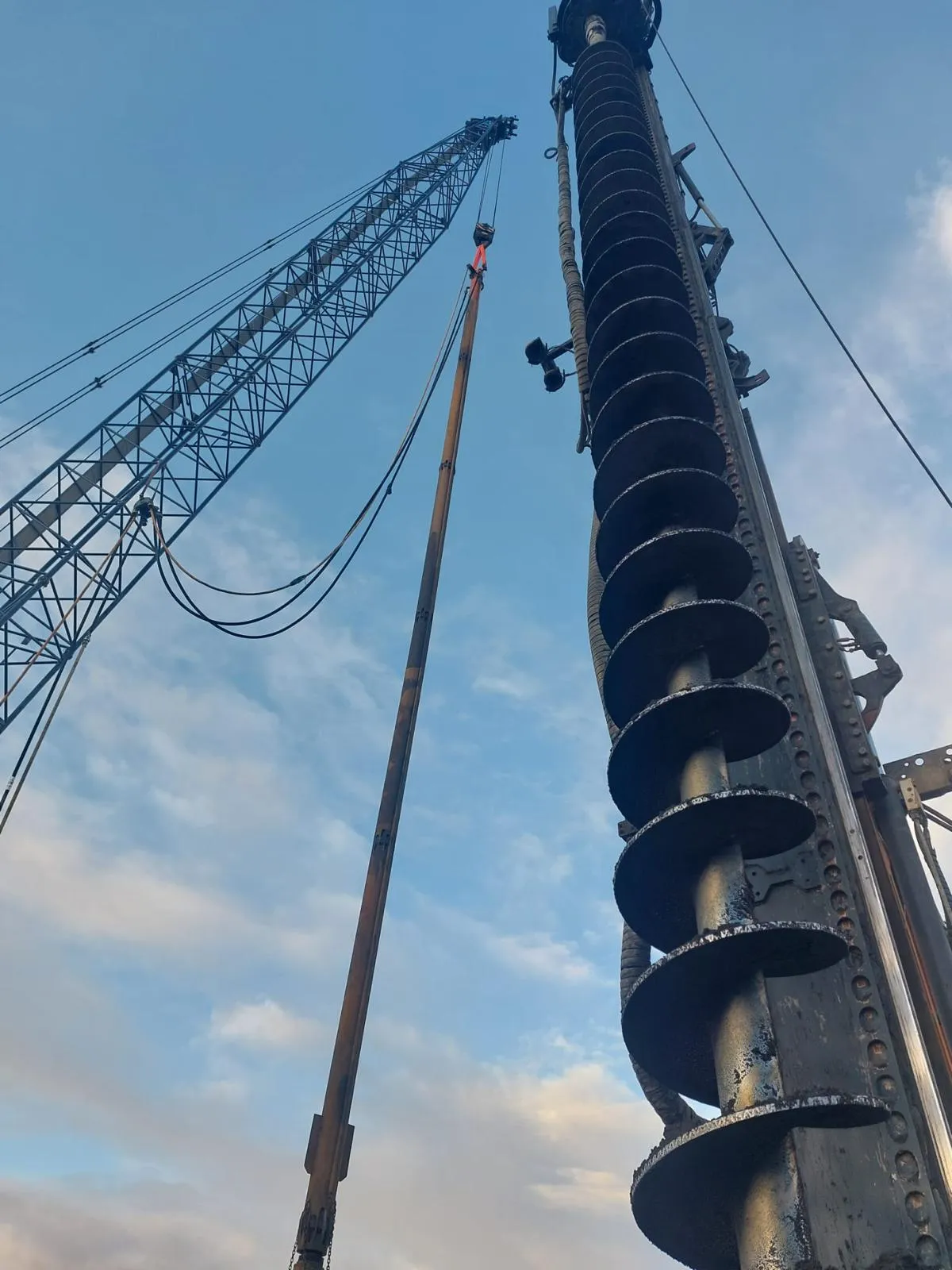 A crane is lifting a large piece of equipment.